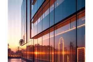 An abstract graphic overlay of energy consumption data on a modern hotel façade at sunset, indicating smart energy management.